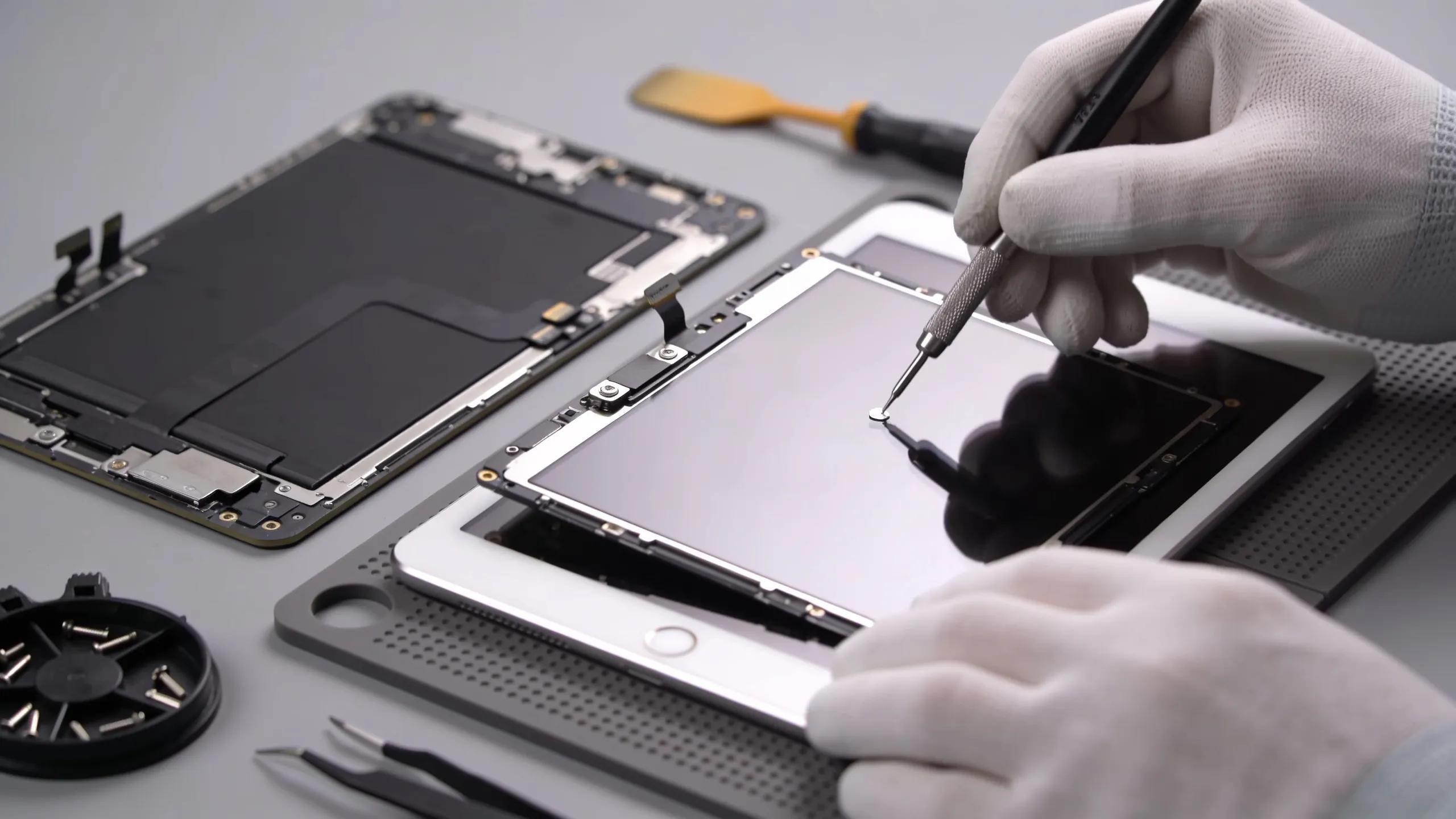 iPad being repaired with a new screen installed, highlighting the precision of the repair process